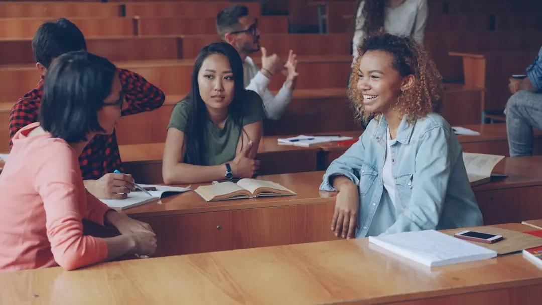Two students talking and gesturing as they discuss an idea after class
