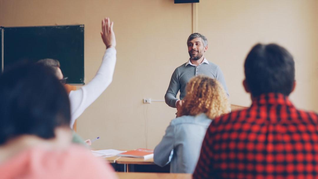 Teacher asking students a question during a classroom discussion